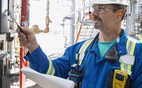 Technician checking equipment in industrial site