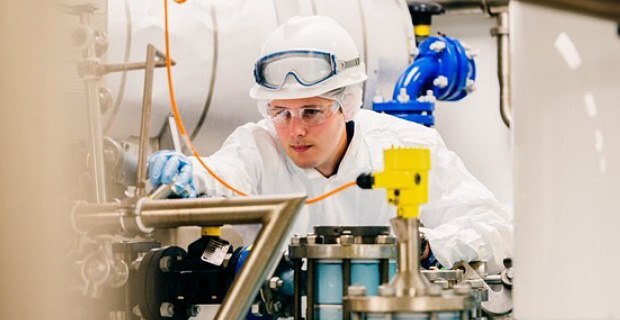 Scientist in lab with hard hat and goggles