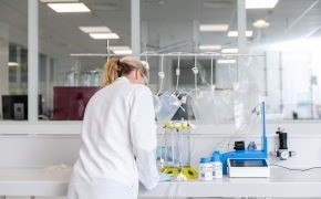 A scientist working on a white counter