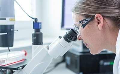 Operator looking into a microscope