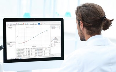 Image of scientist using Belysa® Immunoassay Curve Fitting Software, available for analyzing data from Luminex® xMAP® platforms (xMAP® INTELLIFLEX, Luminex® 200™, FLEXMAP 3D®, MAGPIX® instruments) and the SMCxPRO® ultrasensitive analyzer.